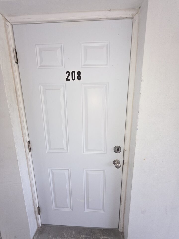 Front door of apartment 208, numbered 208