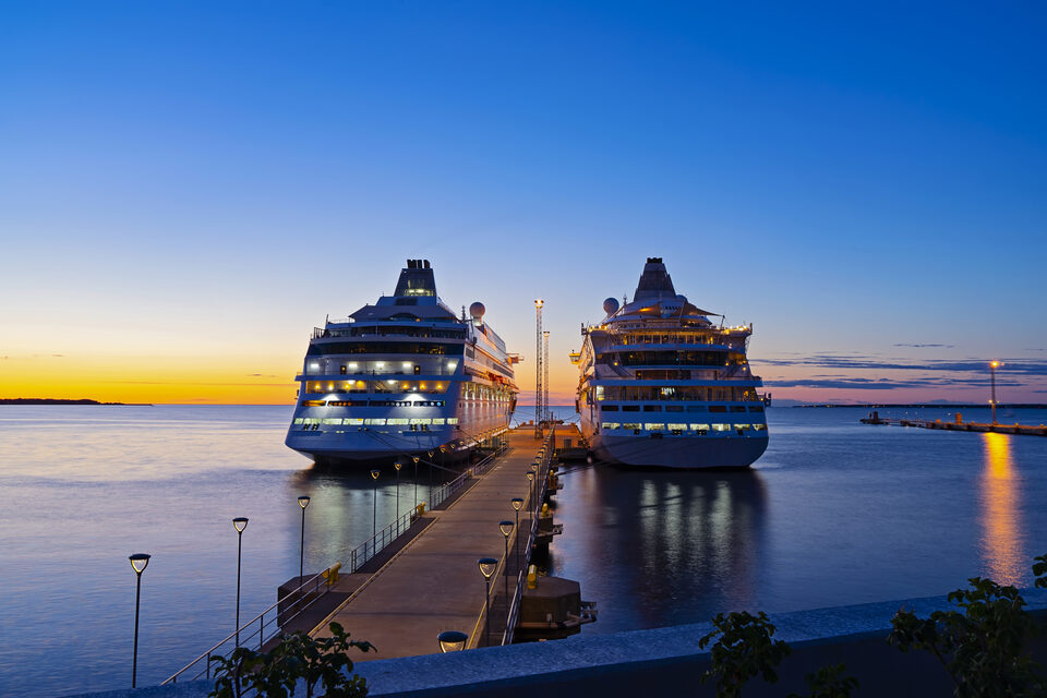 Two cruise liners berthed in port at sunset